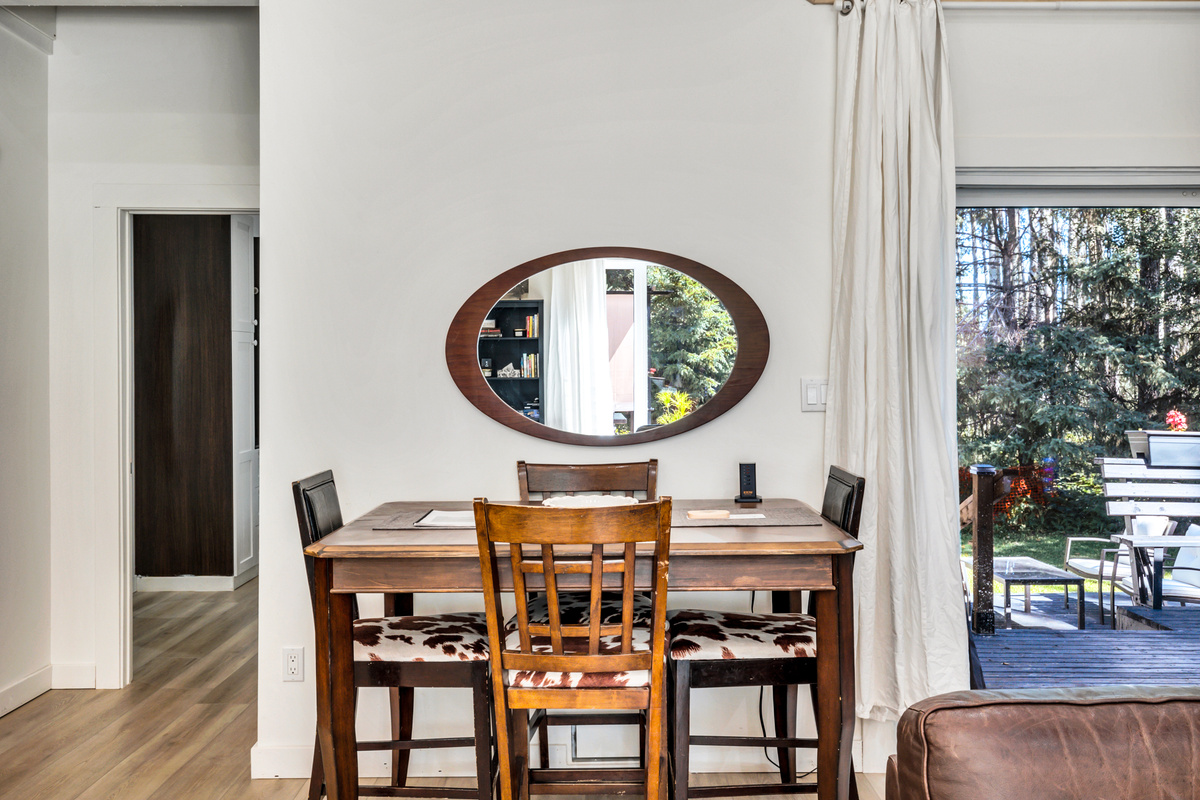 Share meals, play a game, or linger over morning coffee at the dining table, conveniently located beside the kitchen and back deck.