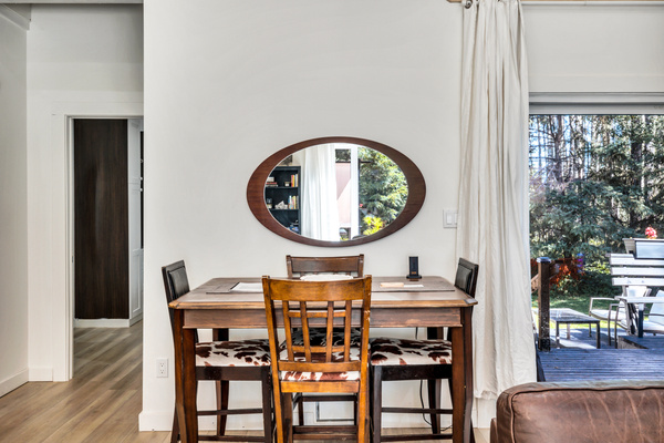 Share meals, play a game, or linger over morning coffee at the dining table, conveniently located beside the kitchen and back deck.