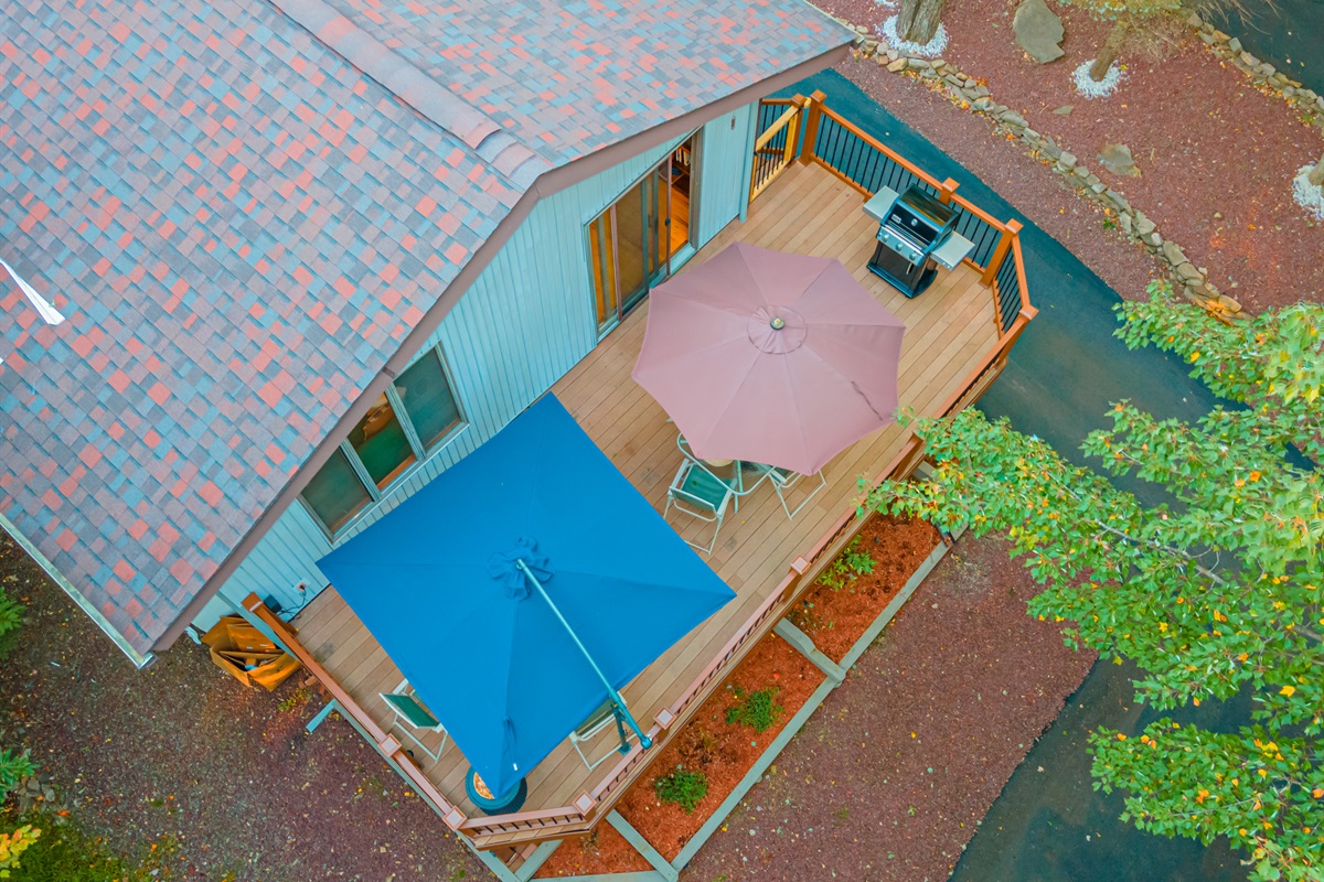 A shaded deck with umbrellas and forest views! Great for meals or morning coffee