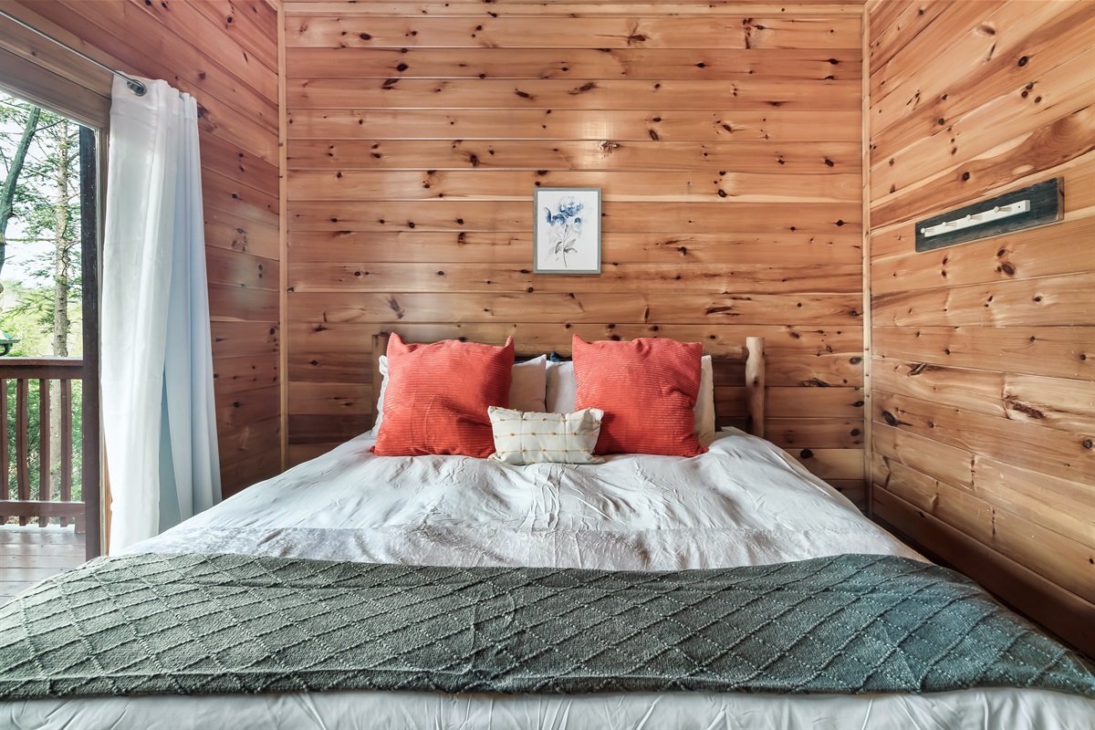 Settle into a lower level king bedroom with easy bathroom access and deck doors that invite fresh mountain air.