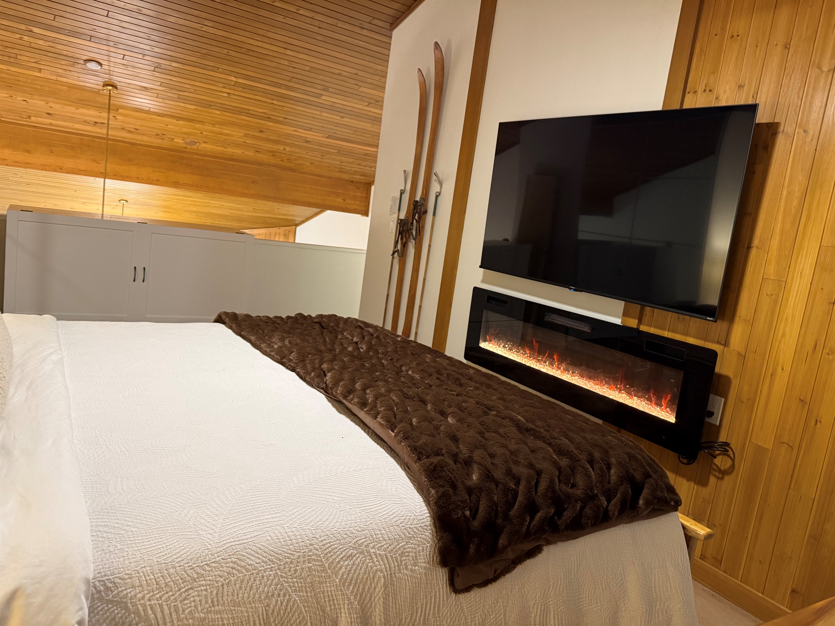 Loft Bedroom Entertainment: Stream your favorite shows on the smart 65" TV enjoying the ambiance of the fireplace. 