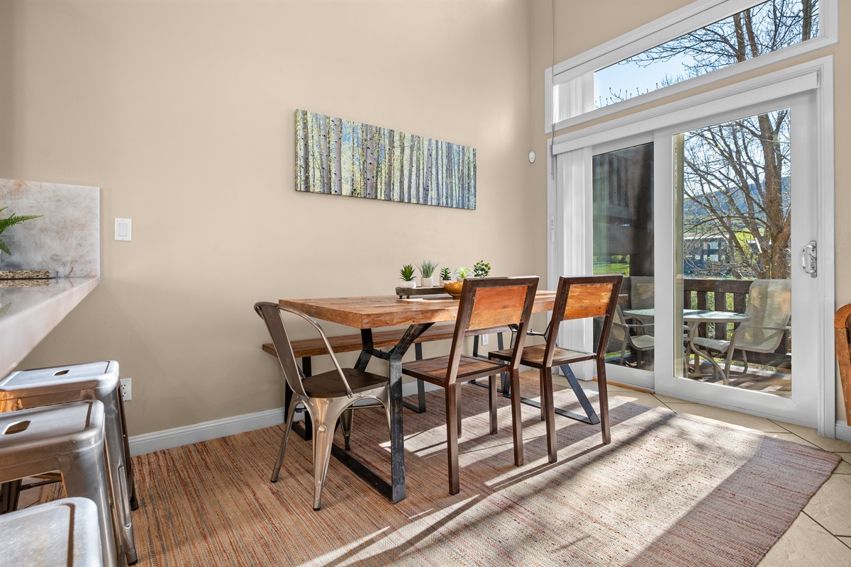 Sunlit dining space with easy access to the outdoor deck and mountain air.