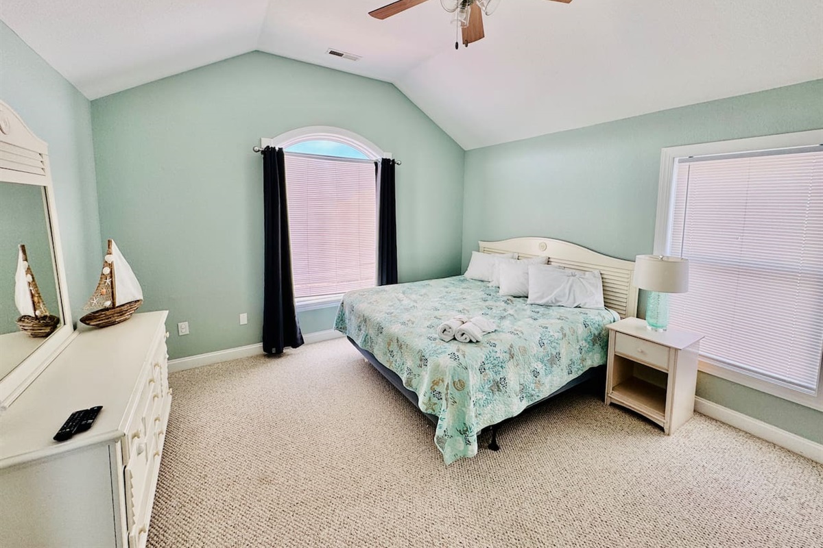 Top-level King bedroom filled with natural light.