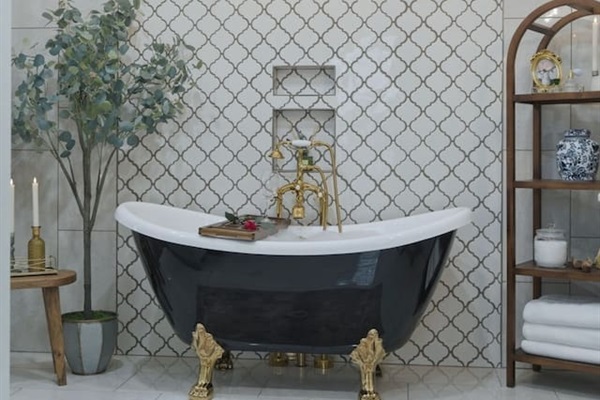 Elegant freestanding tub beneath a statement chandelier, creating a bright and luxurious spa-like ambiance
