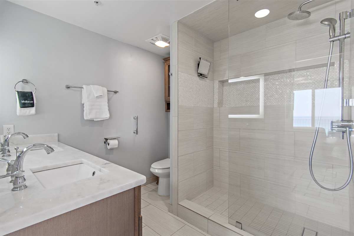 Spacious master bedroom features a King bed, Gulf views, balcony access, SMART TV w/ cable access, remodeled bathroom with walk in shower, and large closet.