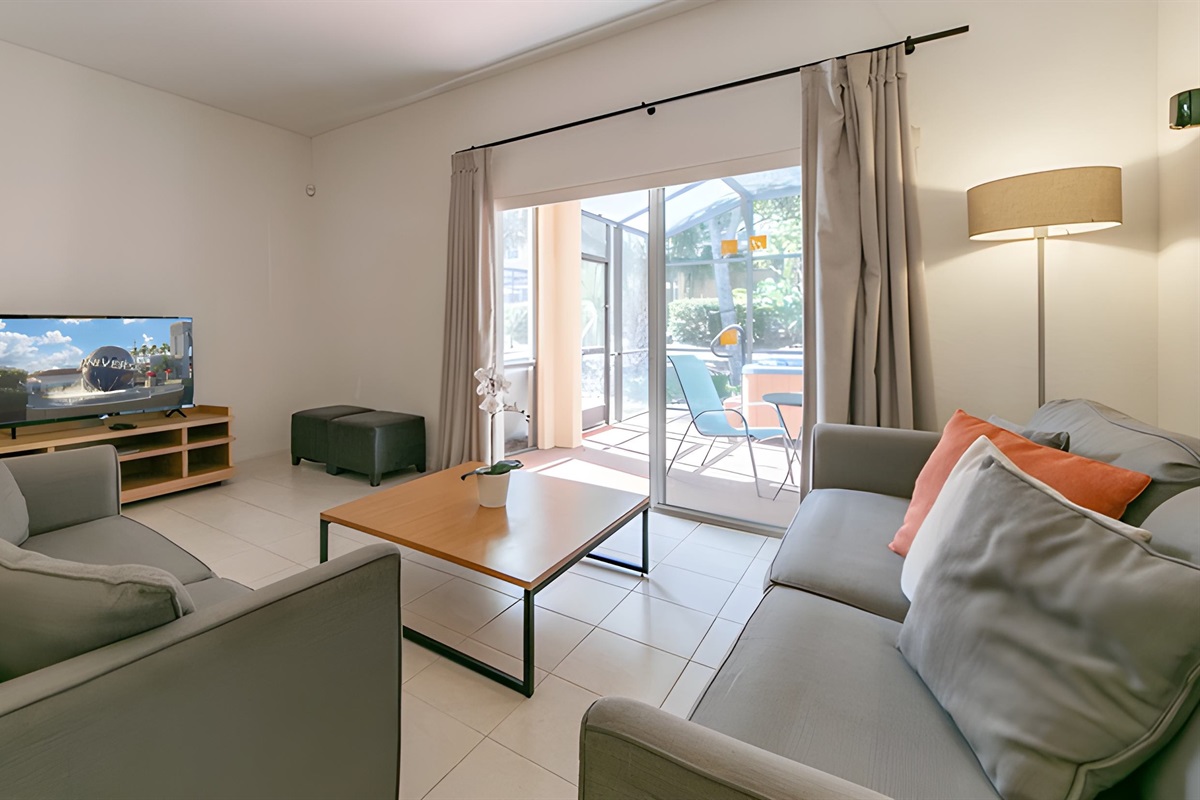 The living area has a 50' smart TV with an Xbox One console, and open view to the private lanai with your own hot tub