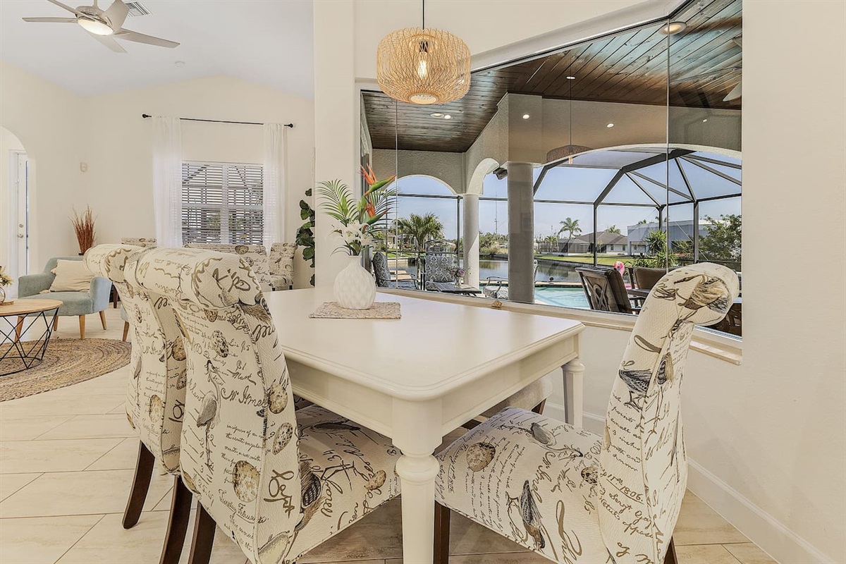 Enjoy the stunning dining area overlooking the pool and water!