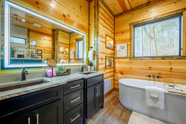 This spacious ensuite features a walk-in shower, soaking tub, and high-end finishes