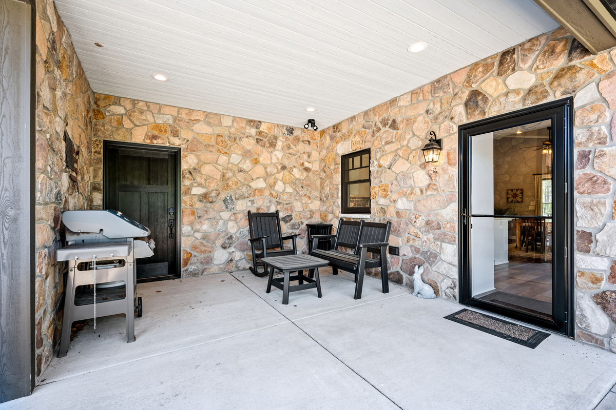 Grill out and relax on the covered stone patio, complete with a gas grill, rocking chairs, and a screen door leading straight to the kitchen.