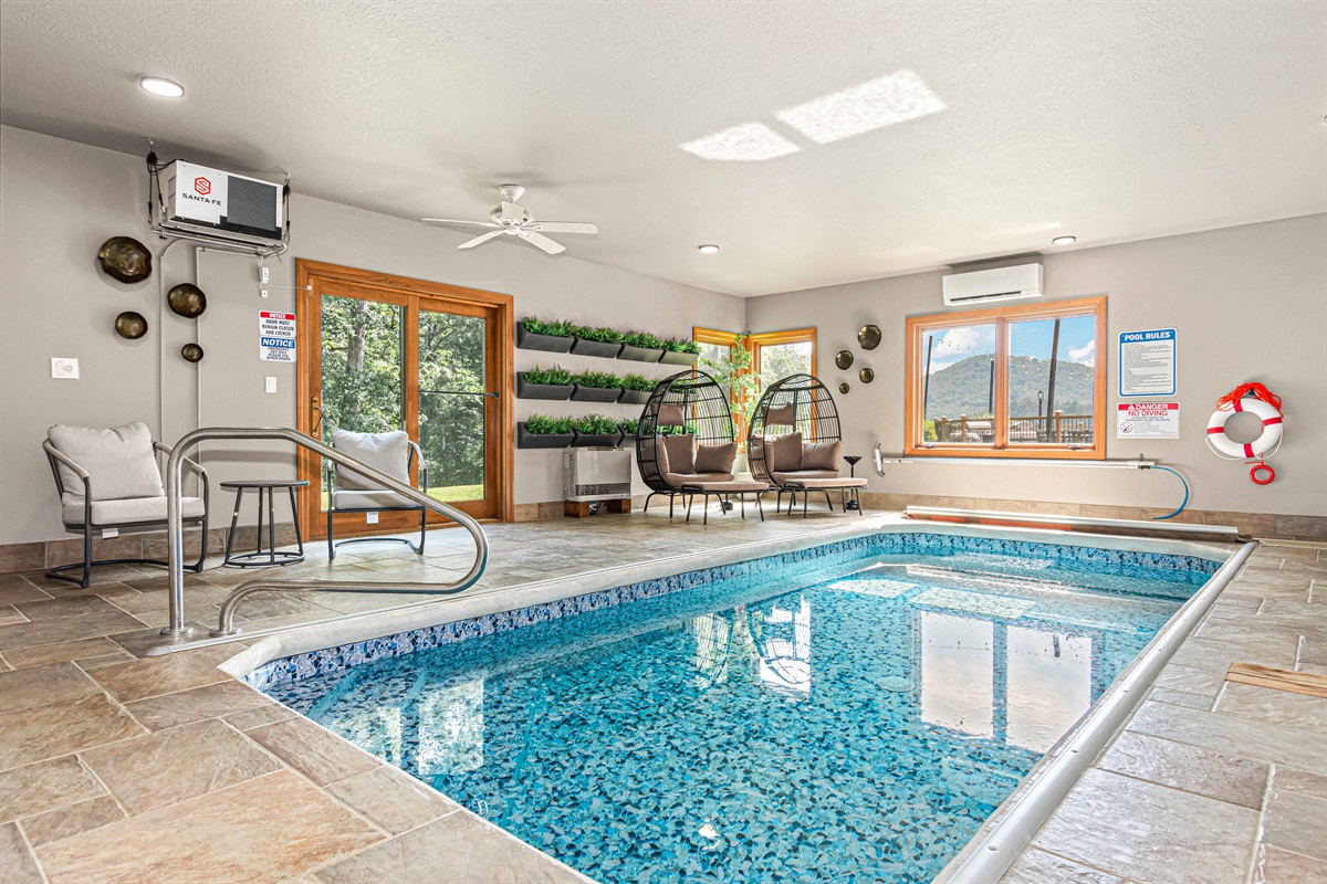 The Only Indoor Pool Vacation Home in all of Asheville area! Swim year-round in this light-filled indoor pool room, featuring cozy seating, egg chairs, & tranquil mountain views.