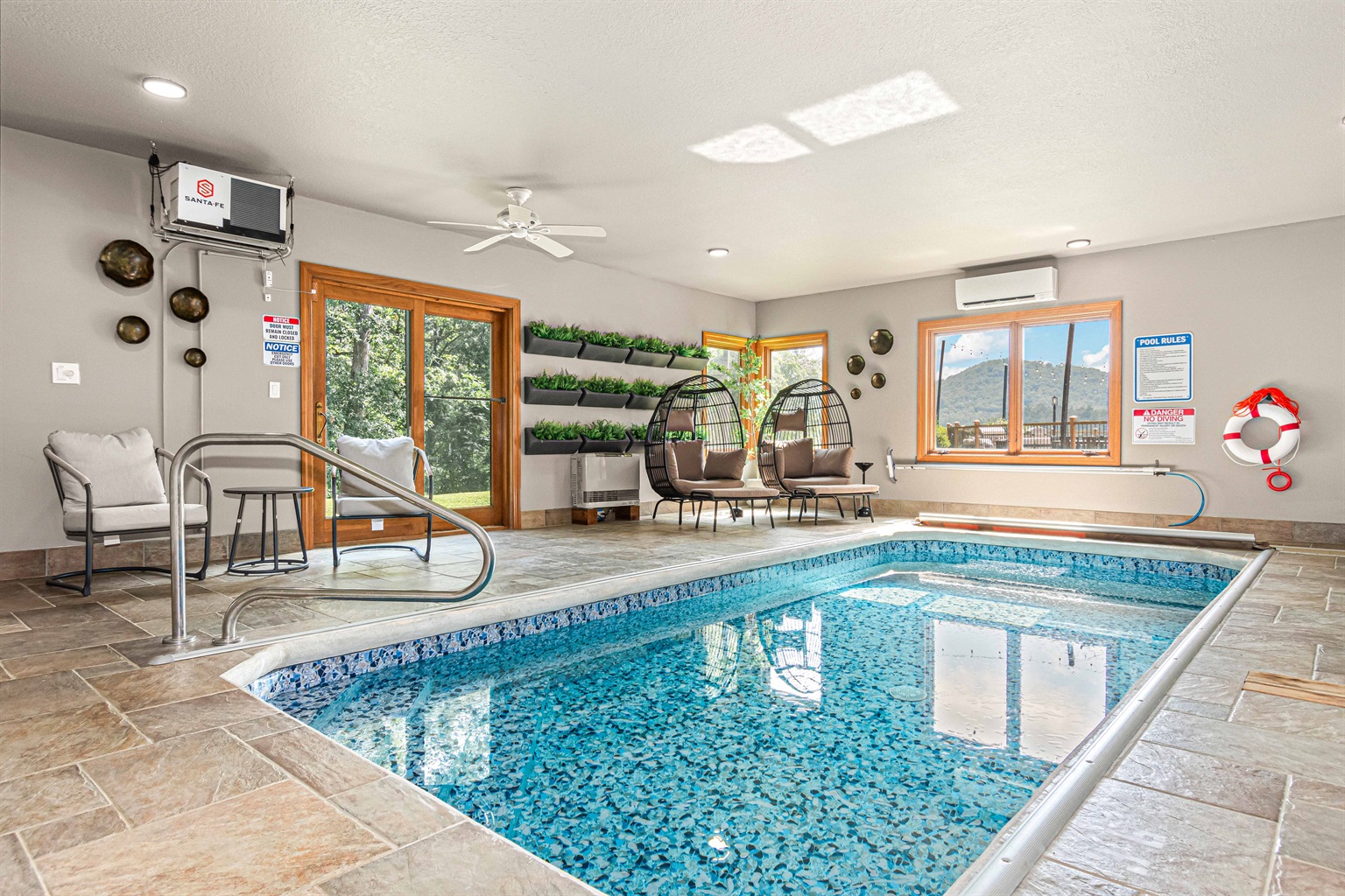 The Only Indoor Pool Vacation Home in all of Asheville area! Swim year-round in this light-filled indoor pool room, featuring cozy seating, egg chairs, & tranquil mountain views.