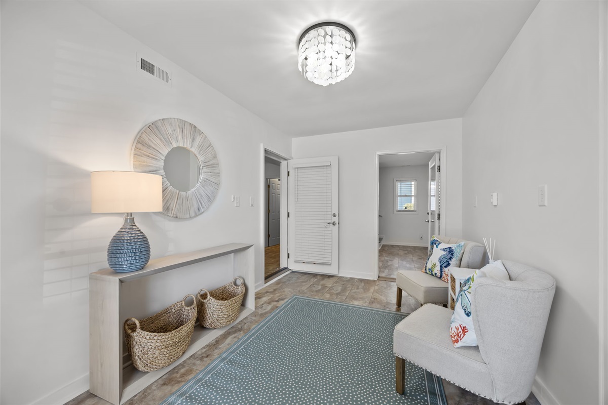 Private ground-level suite featuring a comfortable queen bed, sitting area, TV, and easy access &mdash; perfect for guests who prefer fewer stairs or want extra privacy