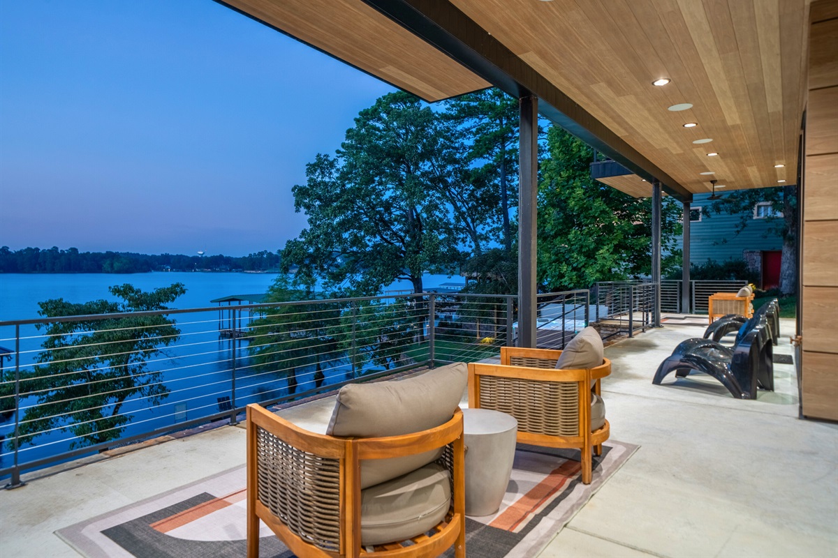 Sip your morning coffee or enjoy an evening cocktail on this gorgeous lakeside balcony. The comfortable seating and beautiful views create a perfect spot for unwinding.