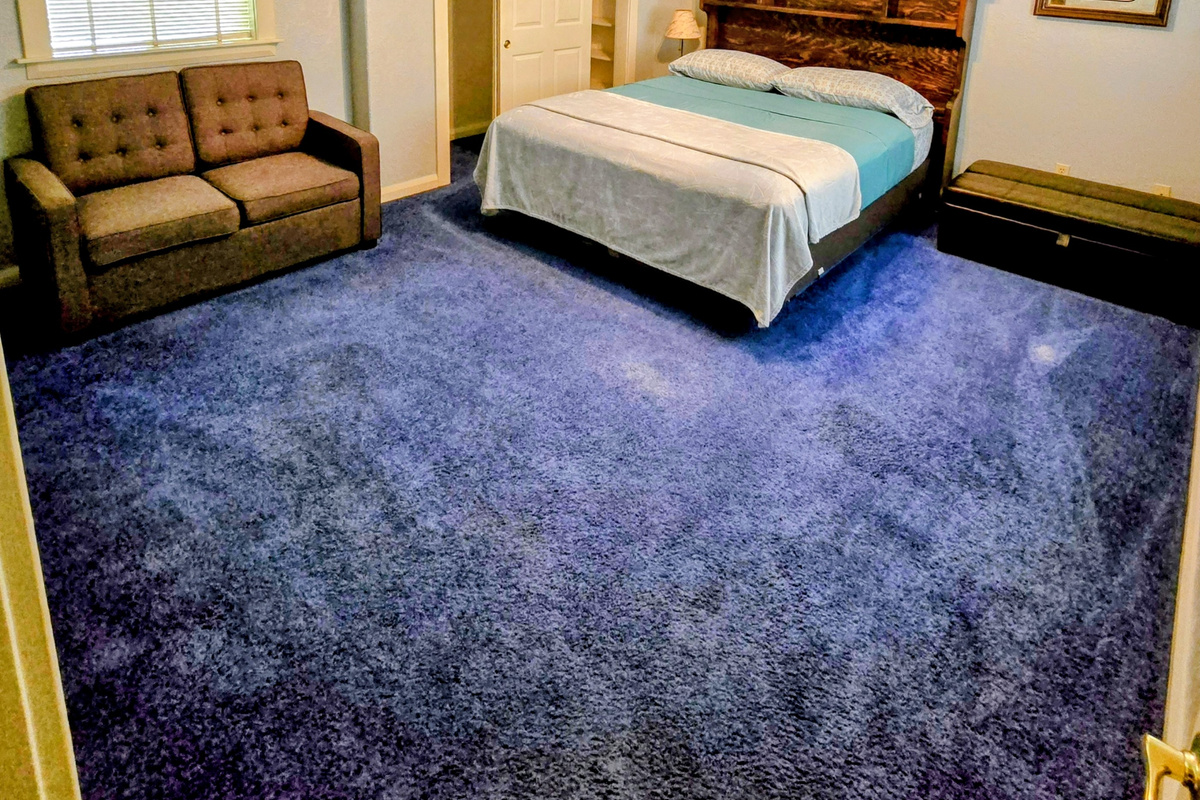 Bedroom 1 with CalKing, above garage
