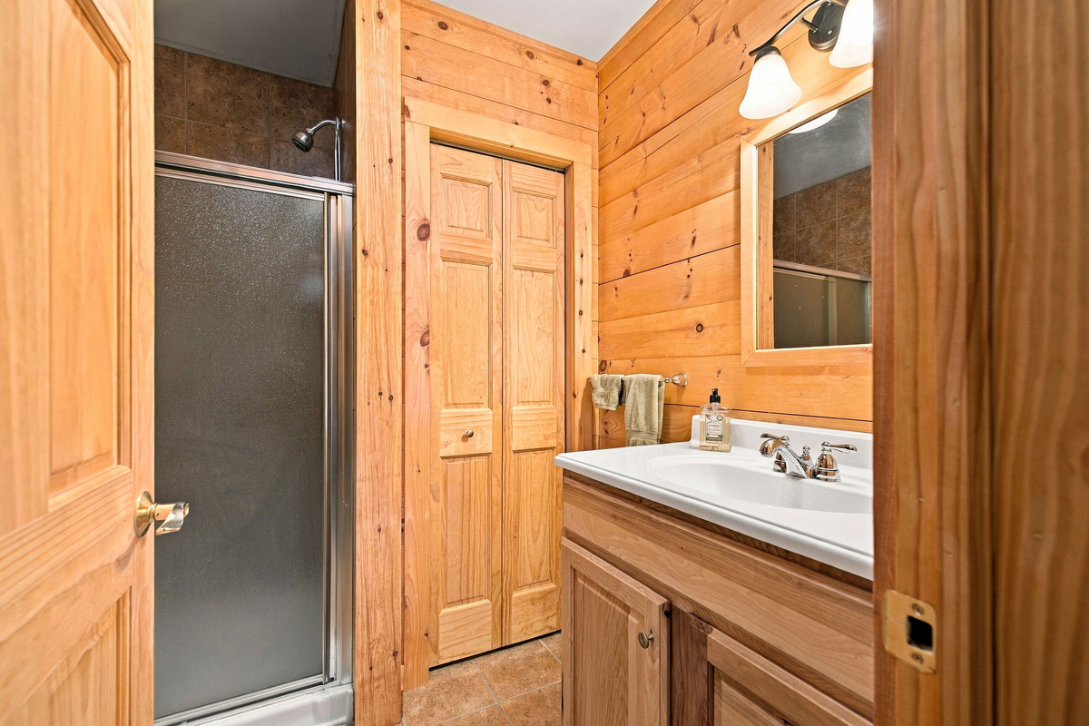 The lower-level bathroom includes a spacious vanity and shower.