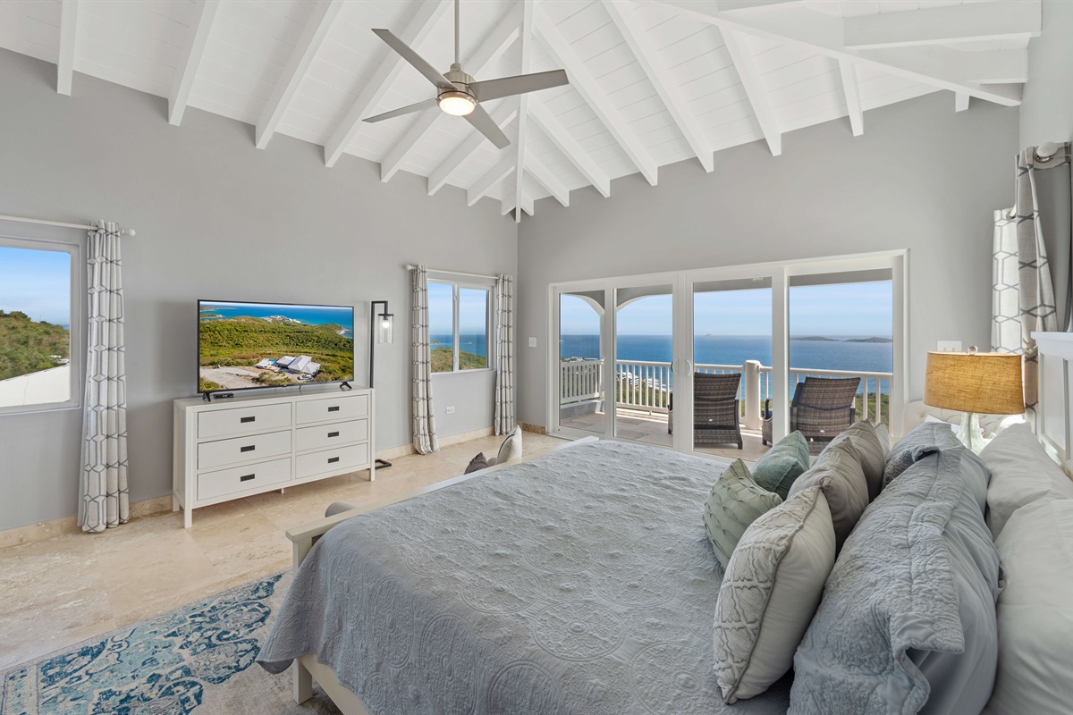 The second-story primary bedroom offers privacy and panoramic sea views.