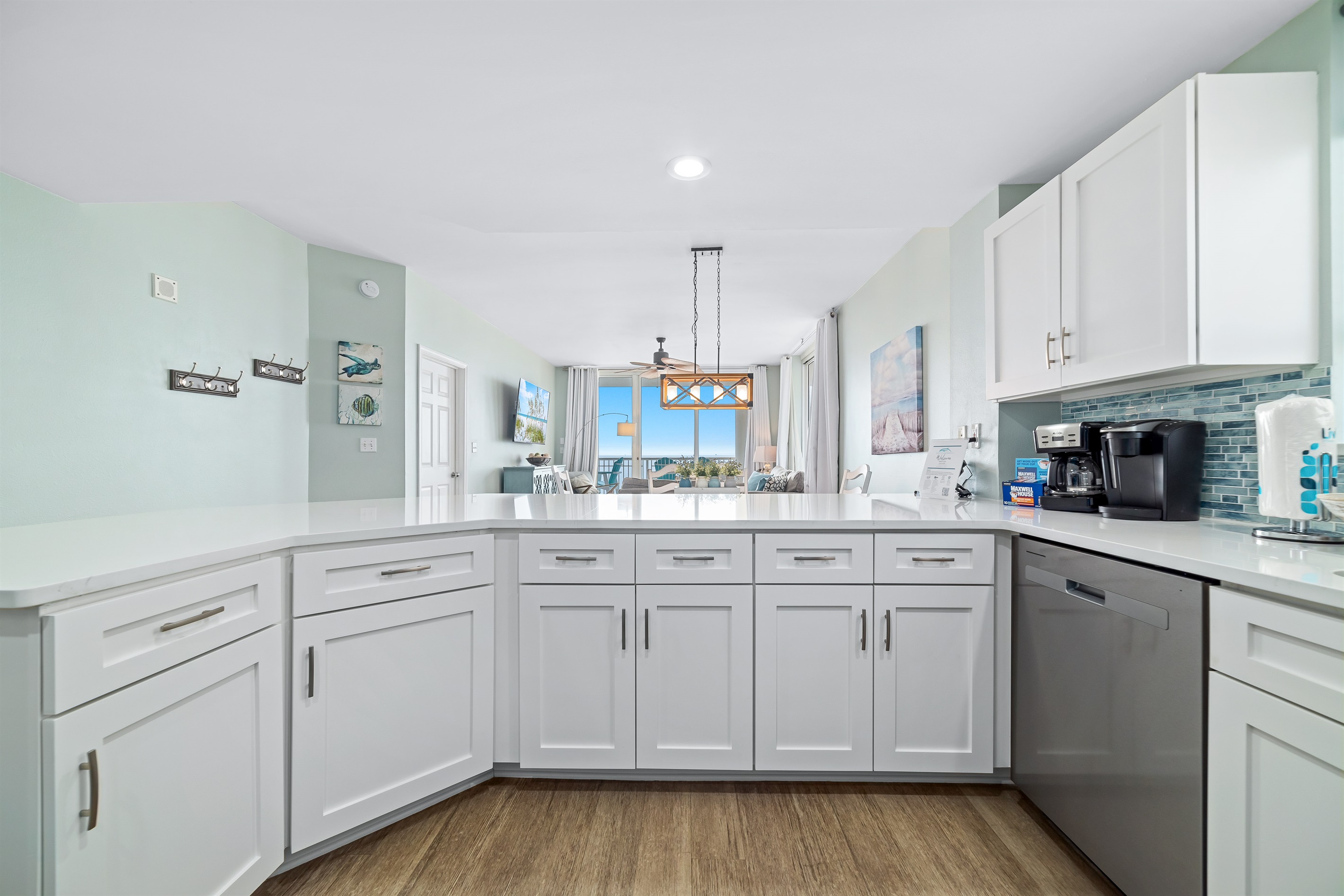 This fully-equipped, modern kitchen features ample counter space is perfectly situated in the open-concept living area, providing unobstructed views of the sparkling ocean while you prepare your favorite meals.