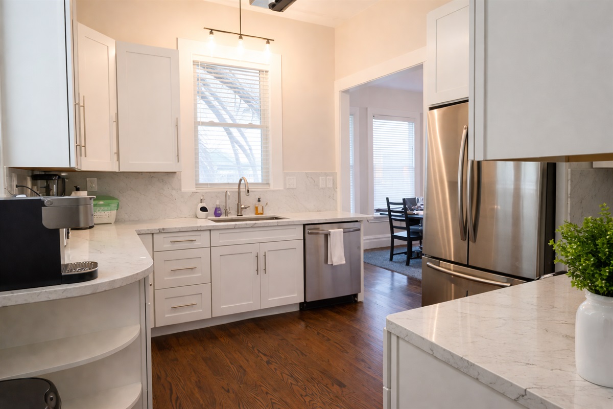 Our bright, clean kitchen is fully equipped with everything you need for a comfortable stay. From the deep stainless steel sink and modern dishwasher to the built-in coffee station, we’ve thought of every detail.
