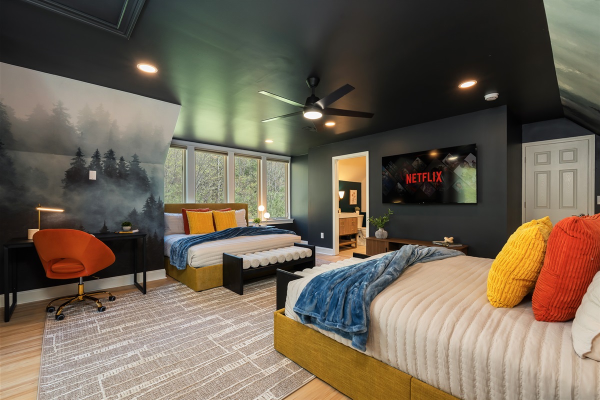 Bedroom with TV, workspace, and en suite bath - well-rounded setup for comfort and flexibility