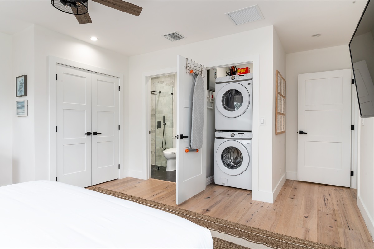 Convenient stacked washer and dryer neatly tucked into a closet for easy access during your stay.