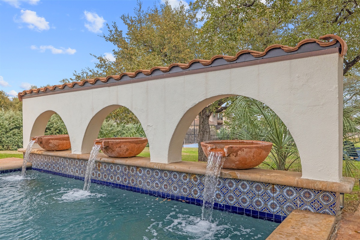 "Unwind in paradise! ✨ This stunning Spanish-style pool features cascading water fountains, intricate tilework, and serene surroundings—perfect for a refreshing dip or a peaceful escape. 🌿💦
