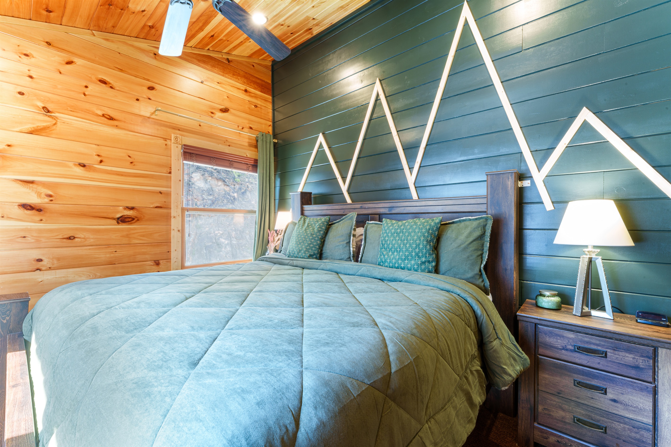 The Emerald Forest Suite has a small closet and TV in the corner.