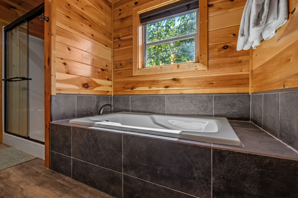 Separate soaking tub in upstairs ensuite bathroom