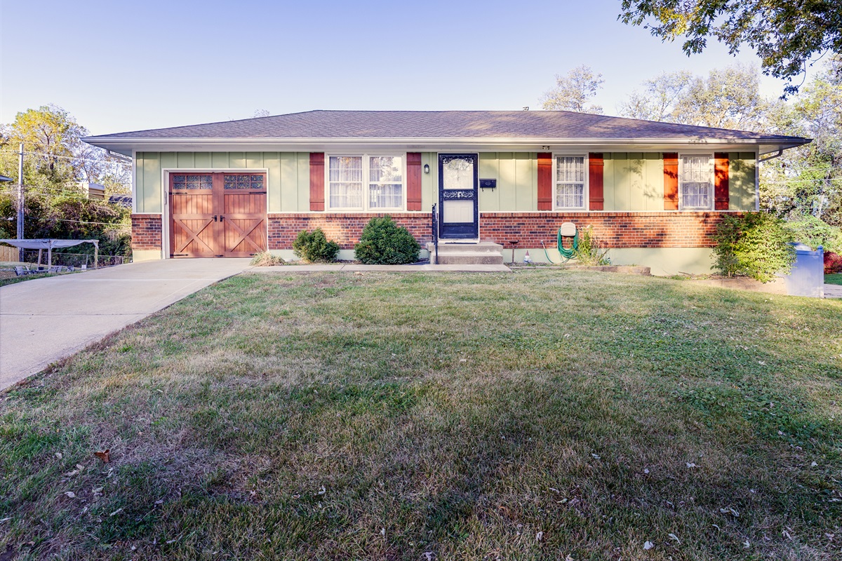 Wide exterior angle showing the home’s clean lines, front lawn, and convenient street access.