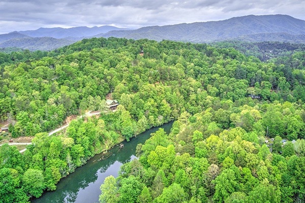 Your ultimate mountain getaway - log cabin surrounded by forest and river below