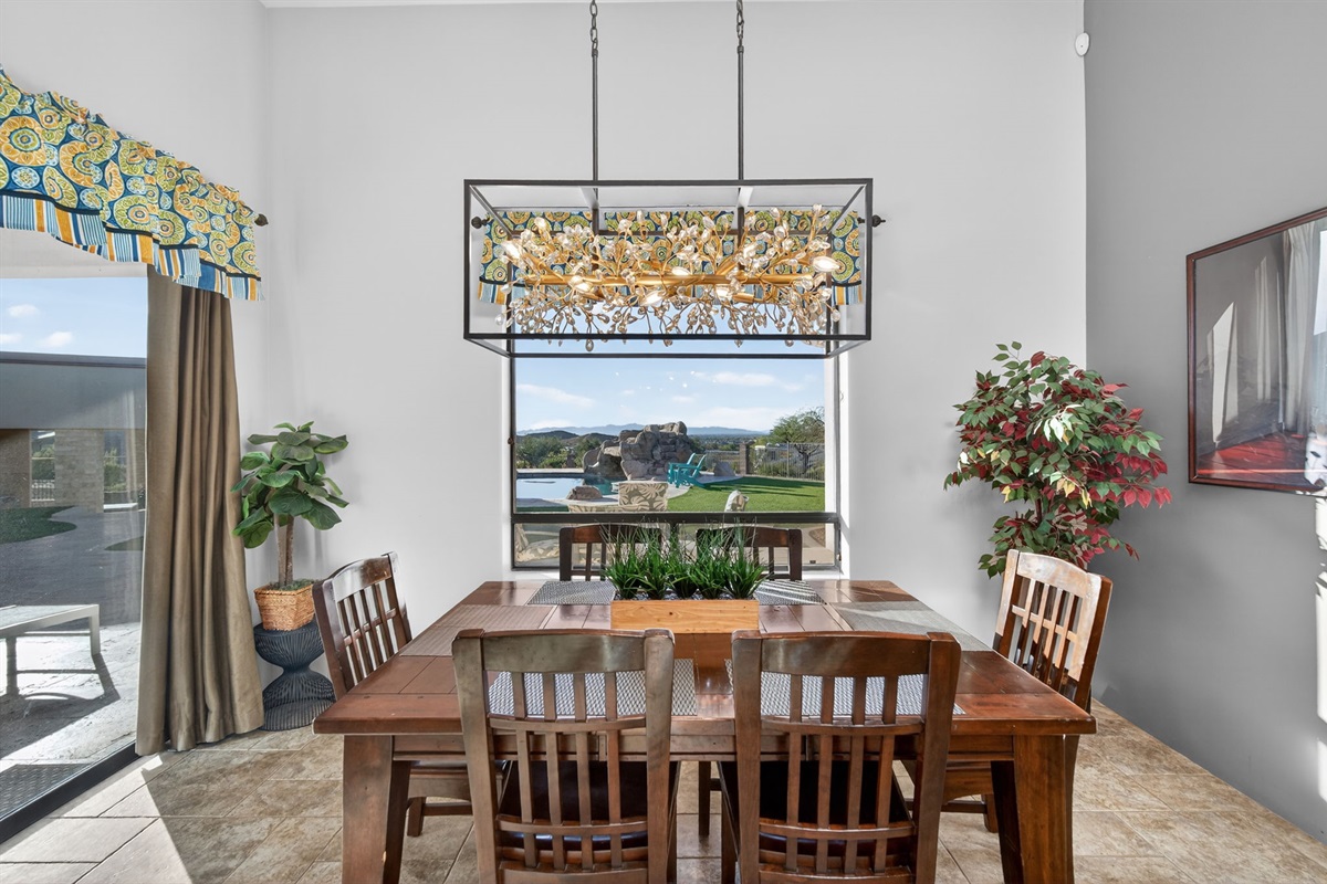 Dining area with scenic backyard views offers a bright setting for shared meals overlooking the desert landscape