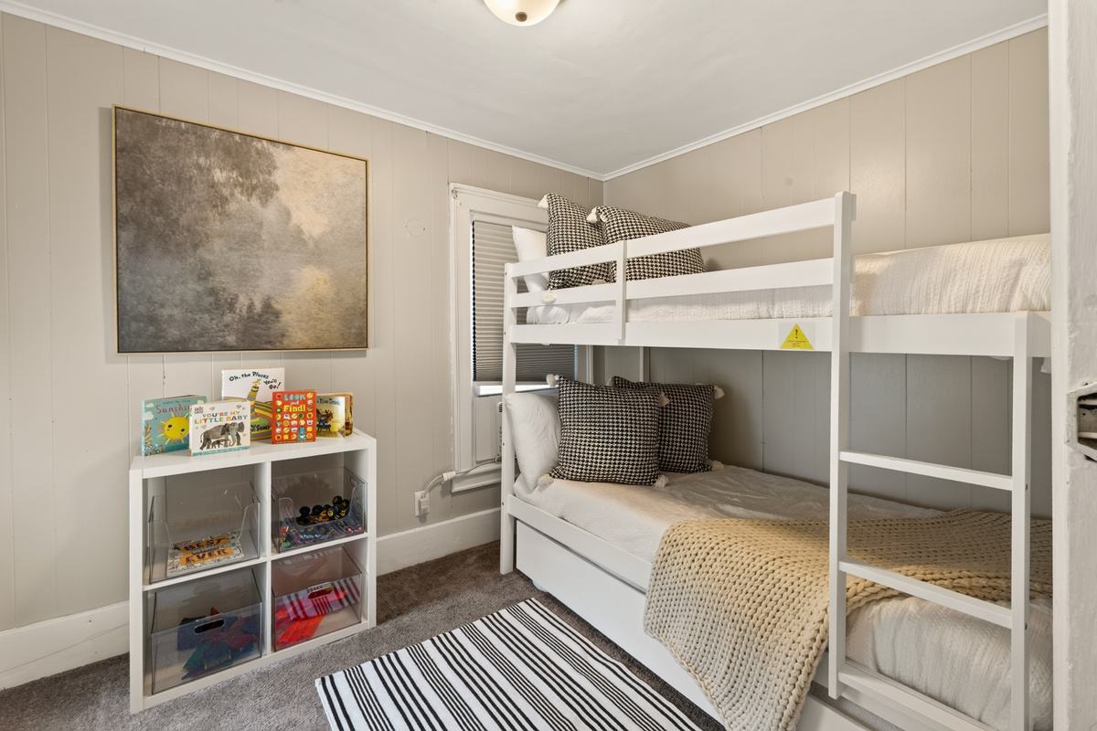 Room with bunk beds and shelves