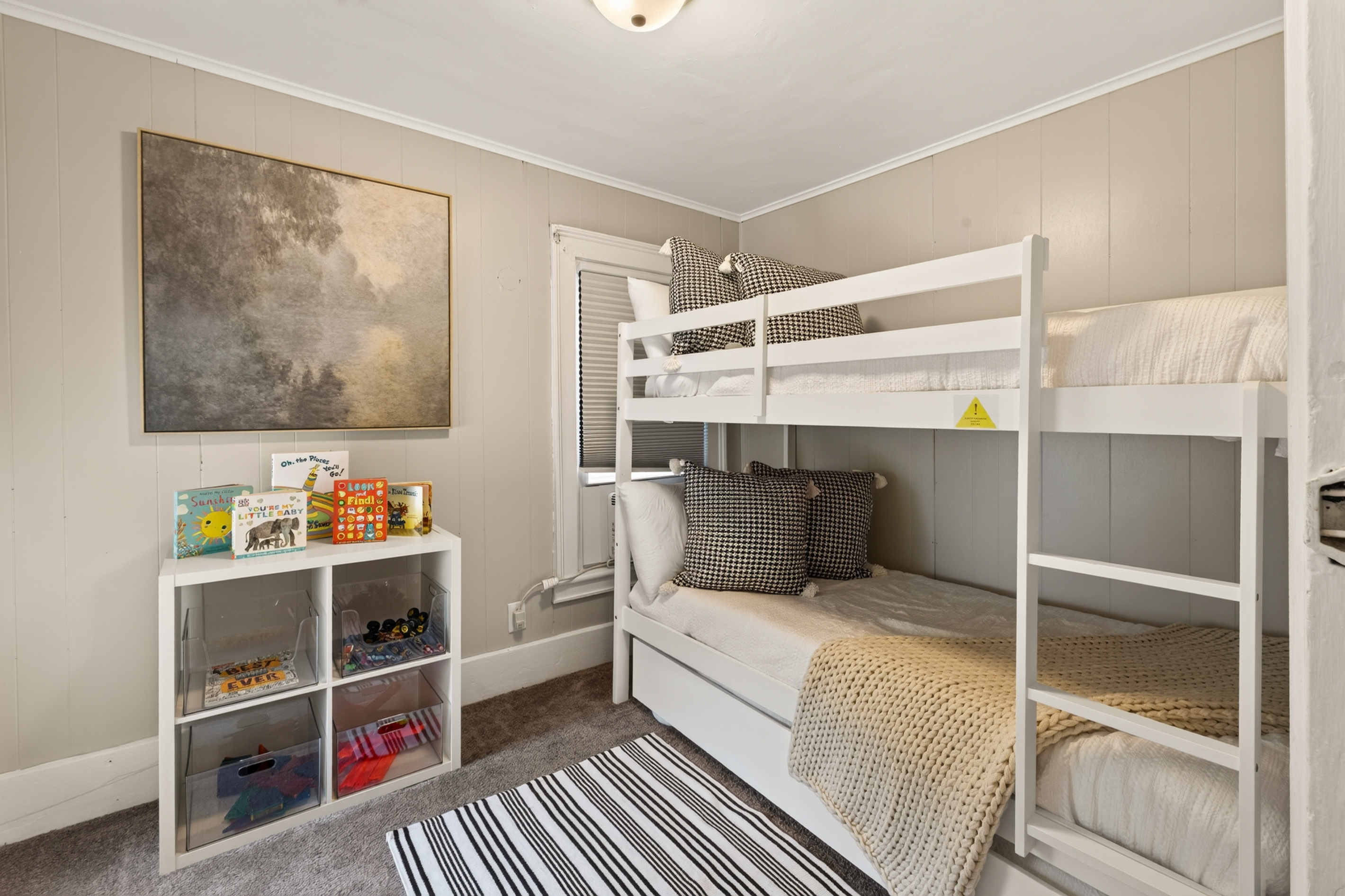 Room with bunk beds and shelves
