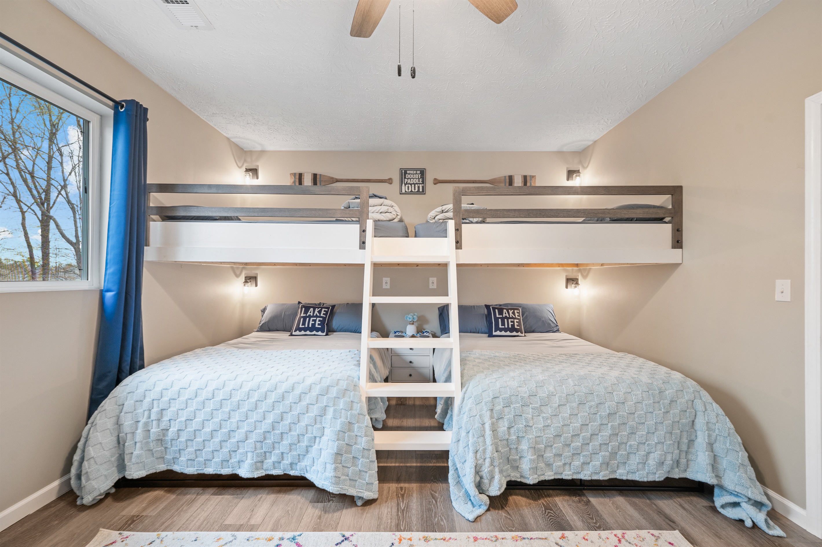 Four full-size bunk beds make this room a fun and cozy retreat for kids and adults alike.