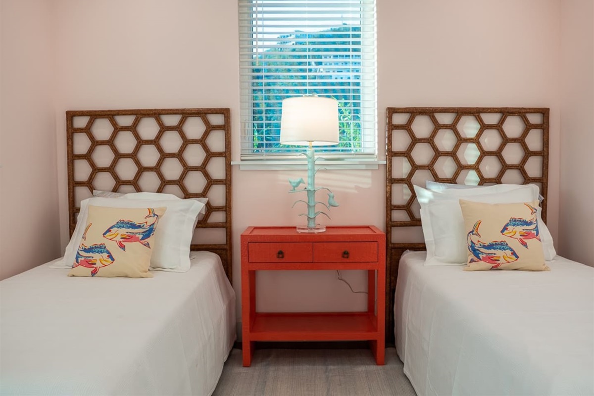 Two twin beds with vibrant decor in Bedroom 1.