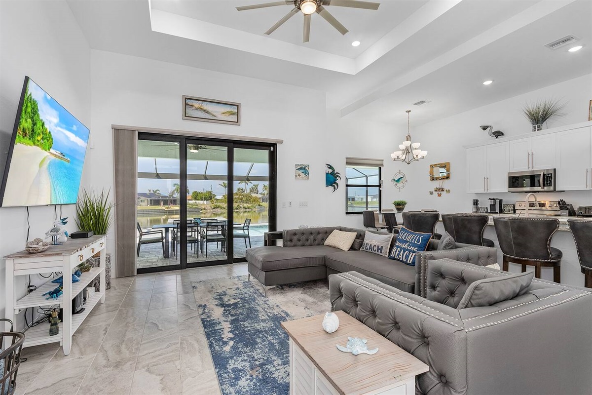 Spacious living room with captivating views of the pool and water