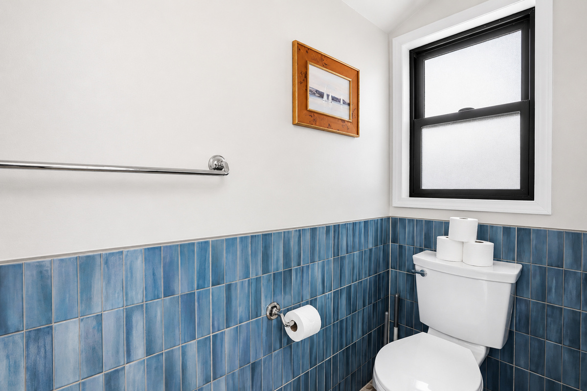 Enjoy the convenience of this modern bathroom located in the indoor pool area, complete with blue tile accents, contemporary finishes, and easy access for guests enjoying the pool.