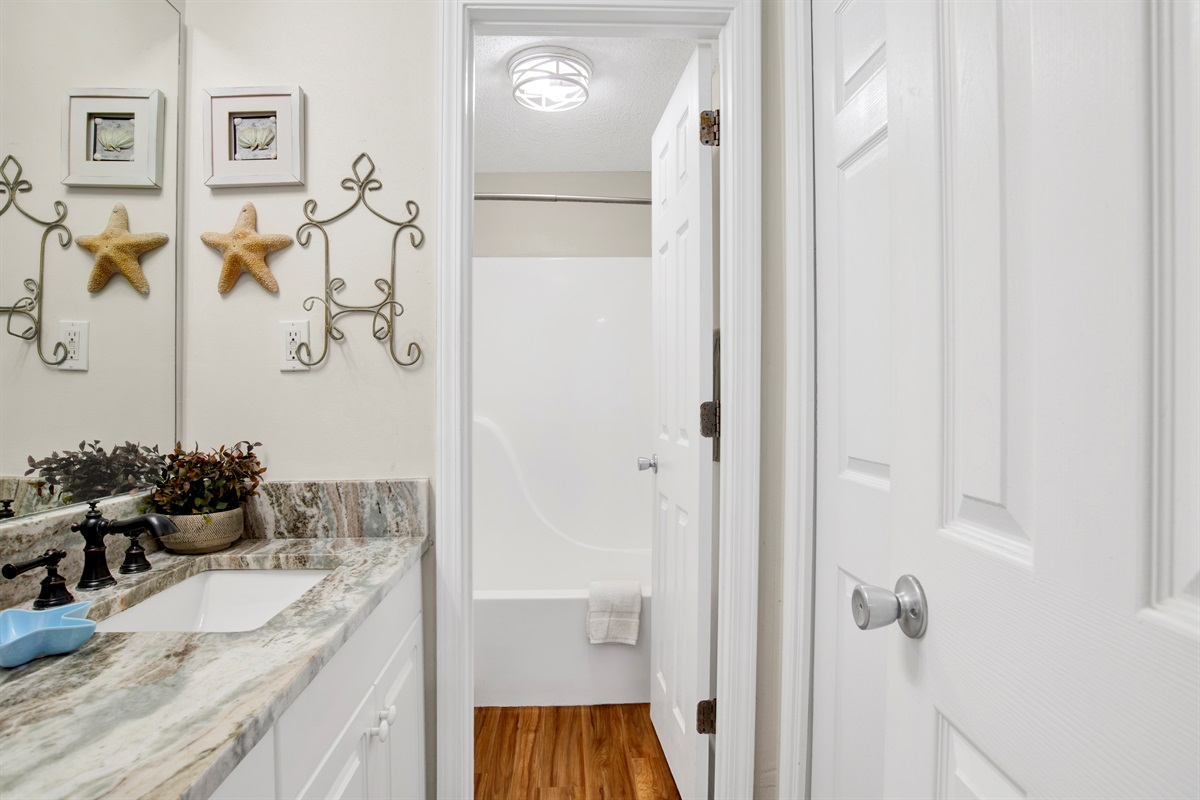 En-suite bathroom with granite tops and a water closet with tub/shower combo 