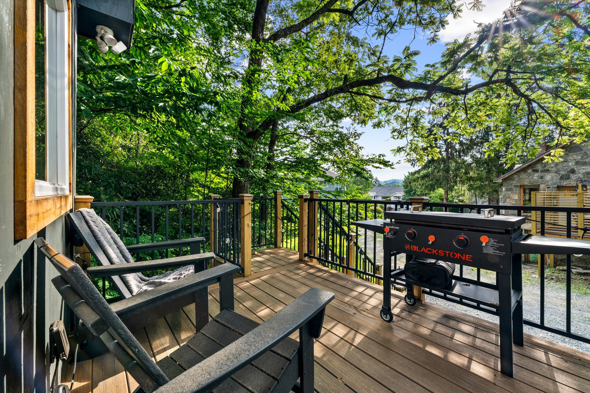 Deck with Blackstone Grill, cafe lights, bistro table and sitting chairs