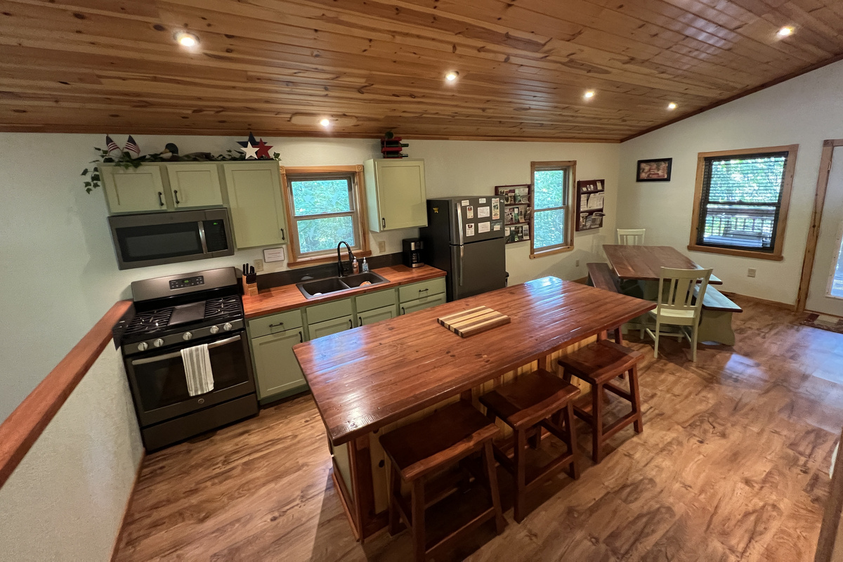 Kitchen area with large island has seating for 4.  Custom wood counter tops.