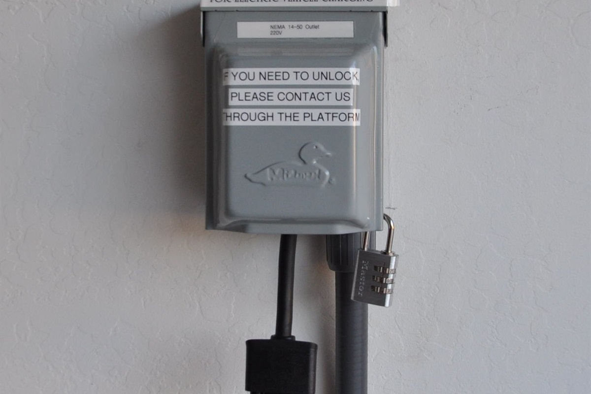 We offer a NEMA 14-50 outlet in the garage (220V) or a standard 110V outlet for you to use. Please note that we do not offer any cords at this time.