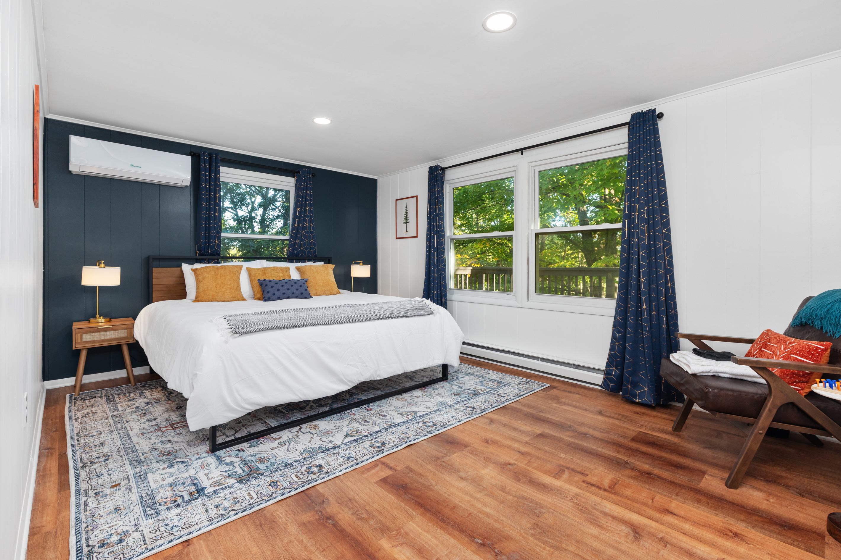 Relax in your room, with a view of the woods surrounding the back deck