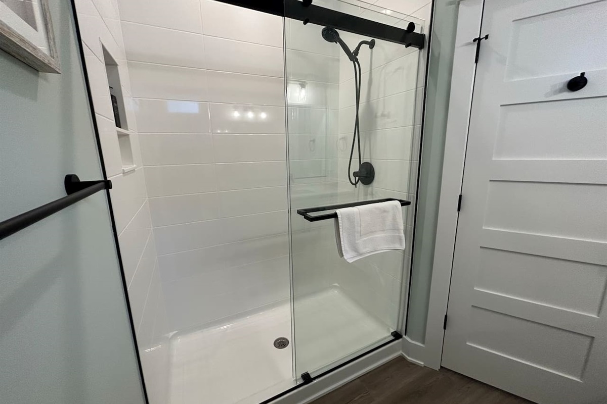 Large shower in the master bathroom is tiled and includes a massage shower head.  