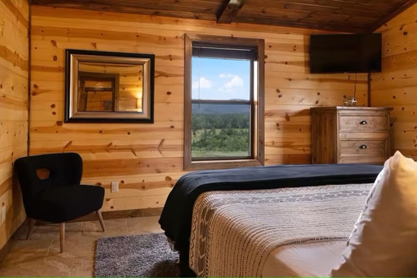 King bedroom with peaceful wooded views.