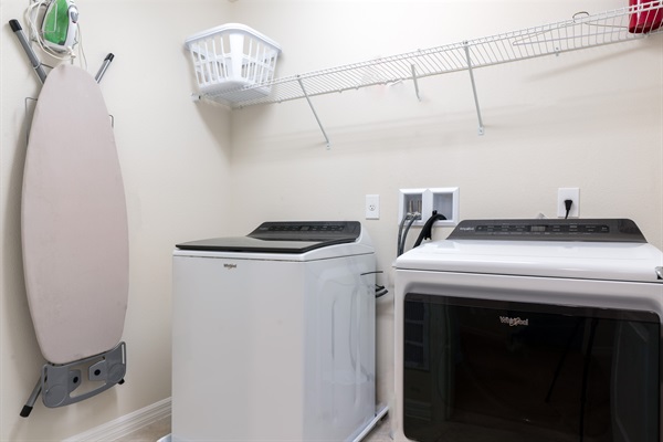 Fully equipped laundry area with a washer & dryer, iron & board, linens, pool towels, and laundry baskets for your convenience.