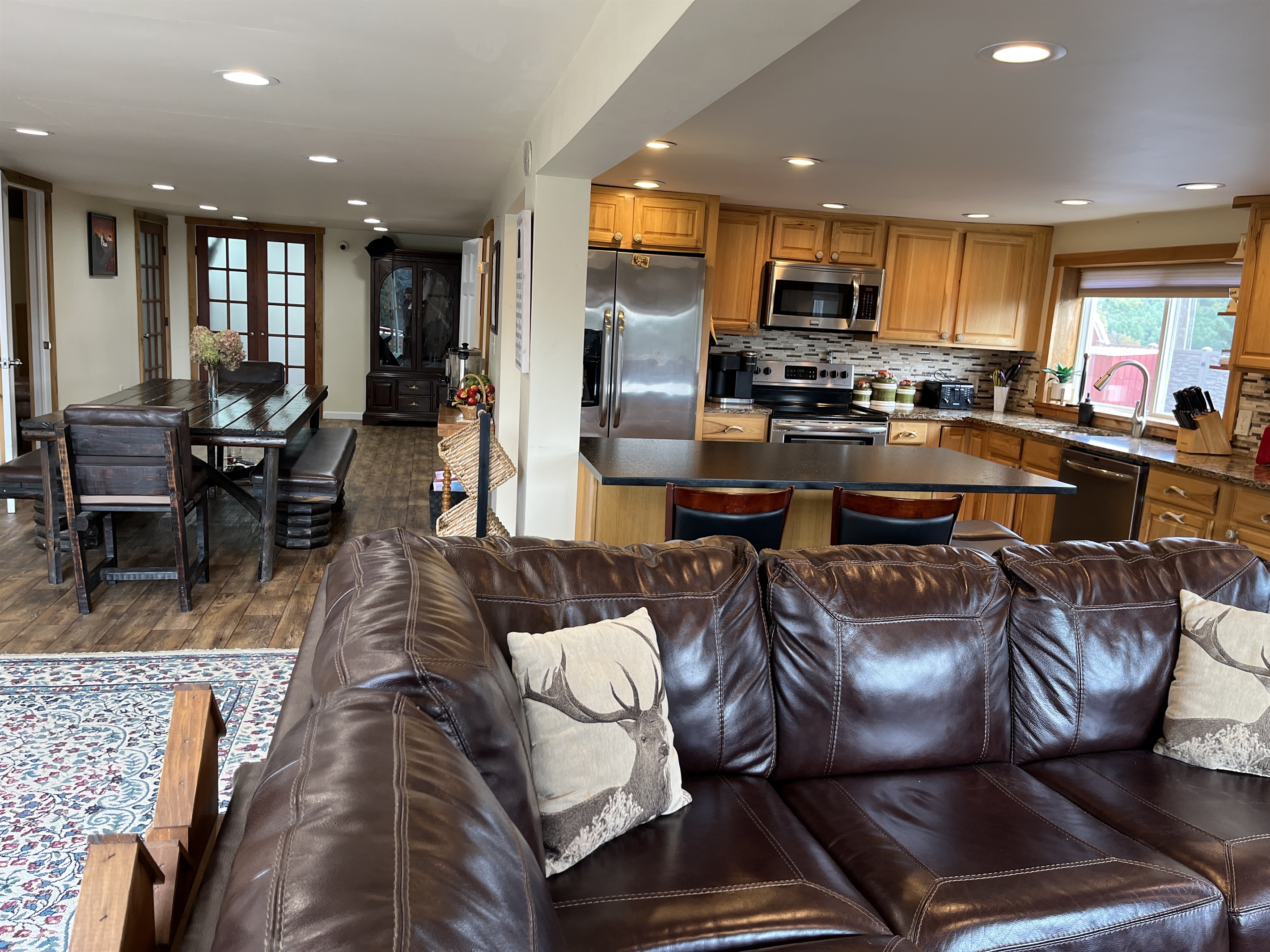 Open concept living, kitchen and dining areas