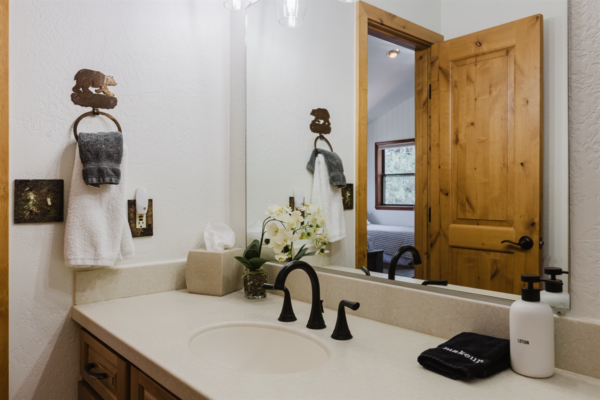 Guests have plenty of counter space, great lighting, and a comfortable shower/tub setup.