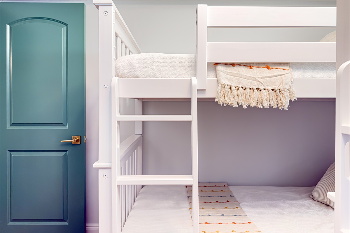 Two sets of bunk beds make this a great room for siblings to share. Everyone gets their own cozy corner to rest and recharge