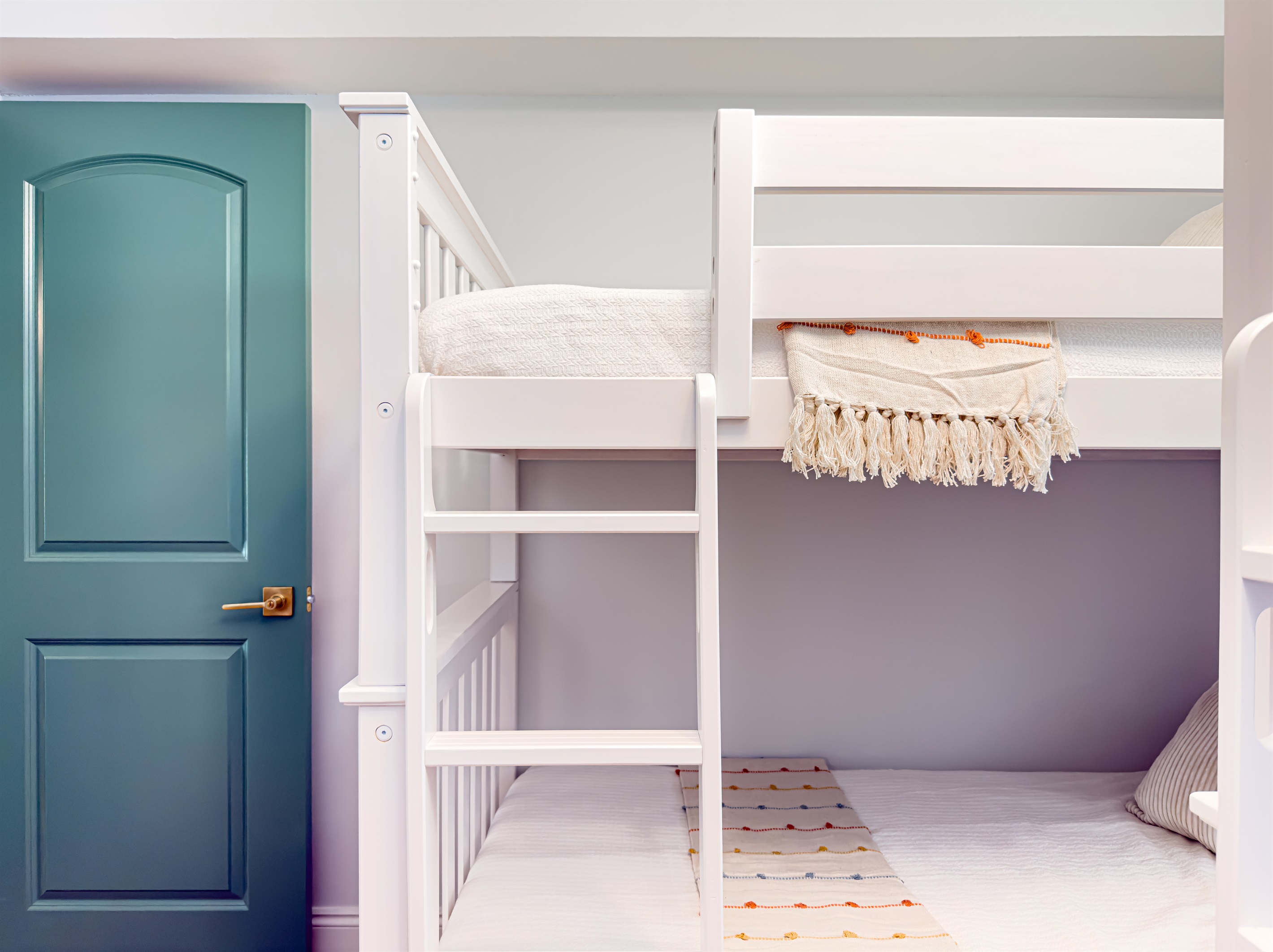 Two sets of bunk beds make this a great room for siblings to share. Everyone gets their own cozy corner to rest and recharge