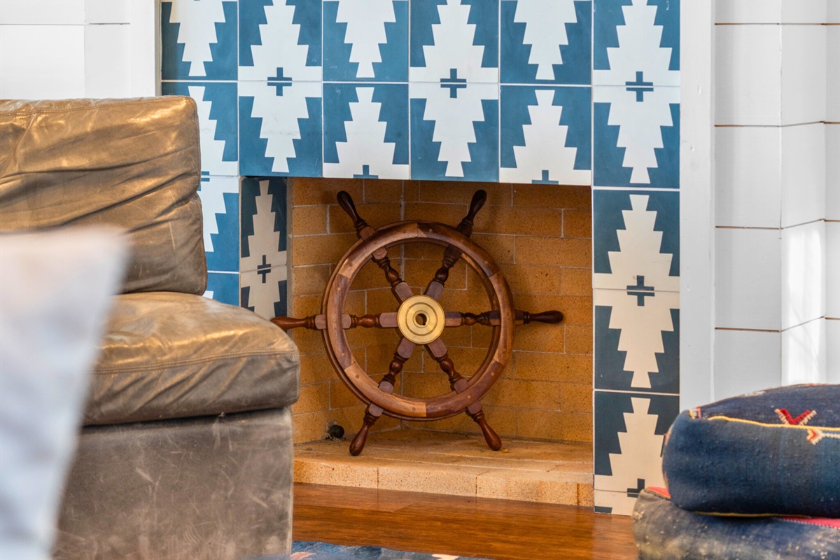 Charming fireplace with a nautical touch—cozy evenings start here.