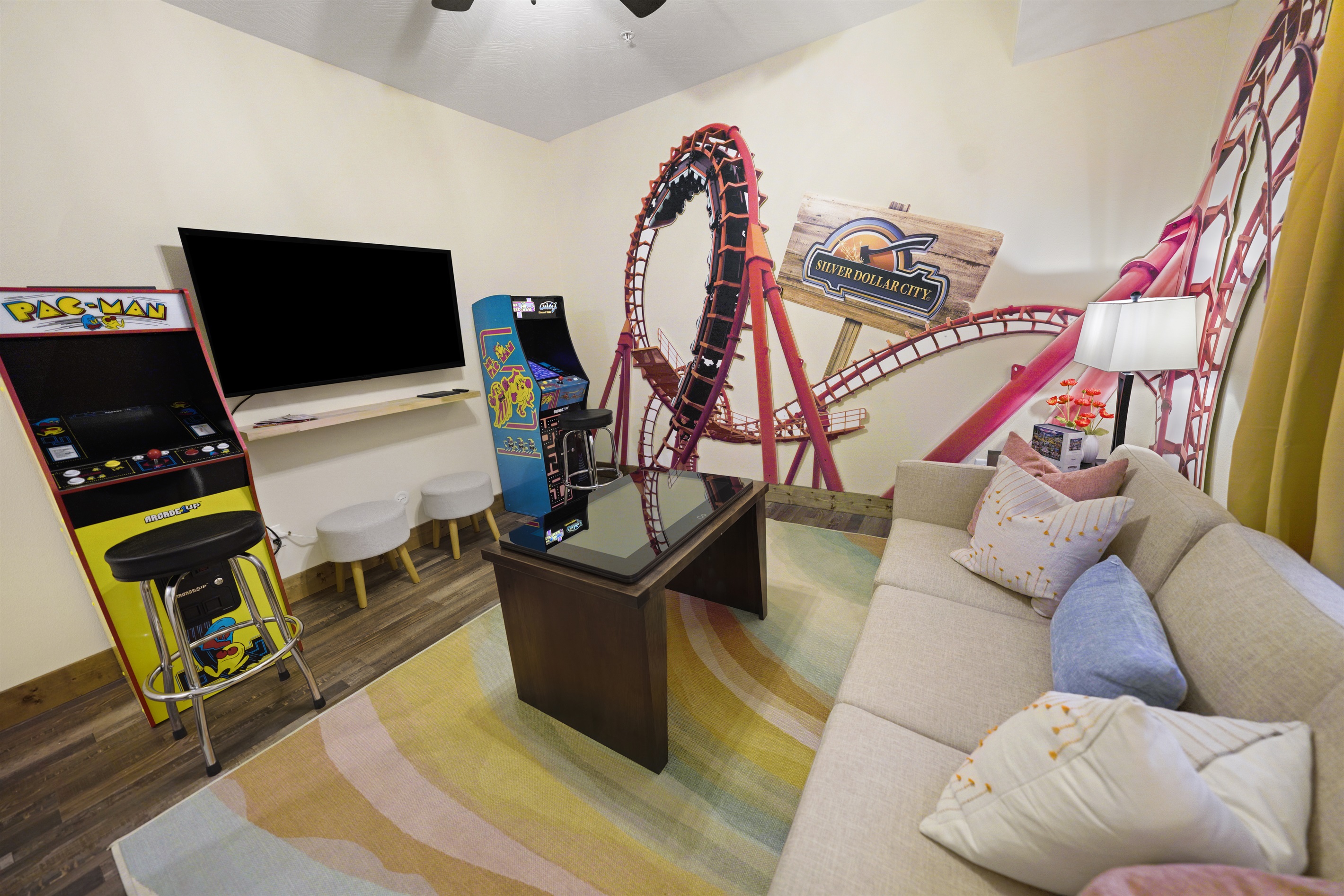 Pac Man games, an infinity game table and large screen tv for watching your favorite show